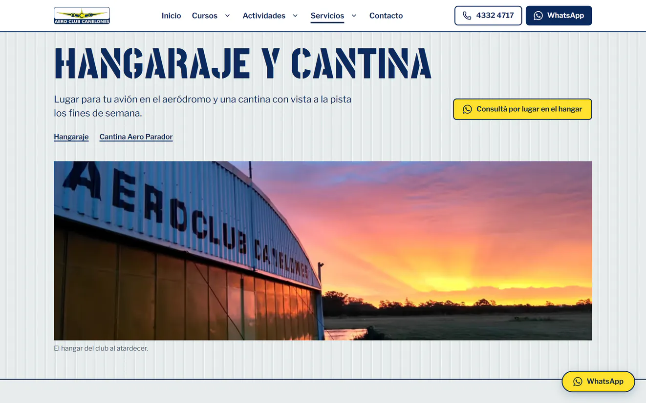 La página de hangaraje y cantina del rediseño: arriba, el logo del club, el menú y los botones de teléfono y WhatsApp; el título en esténcil sobre chapa, el botón amarillo Consultá por lugar en el hangar y la foto del hangar del club al atardecer, con su nombre pintado
